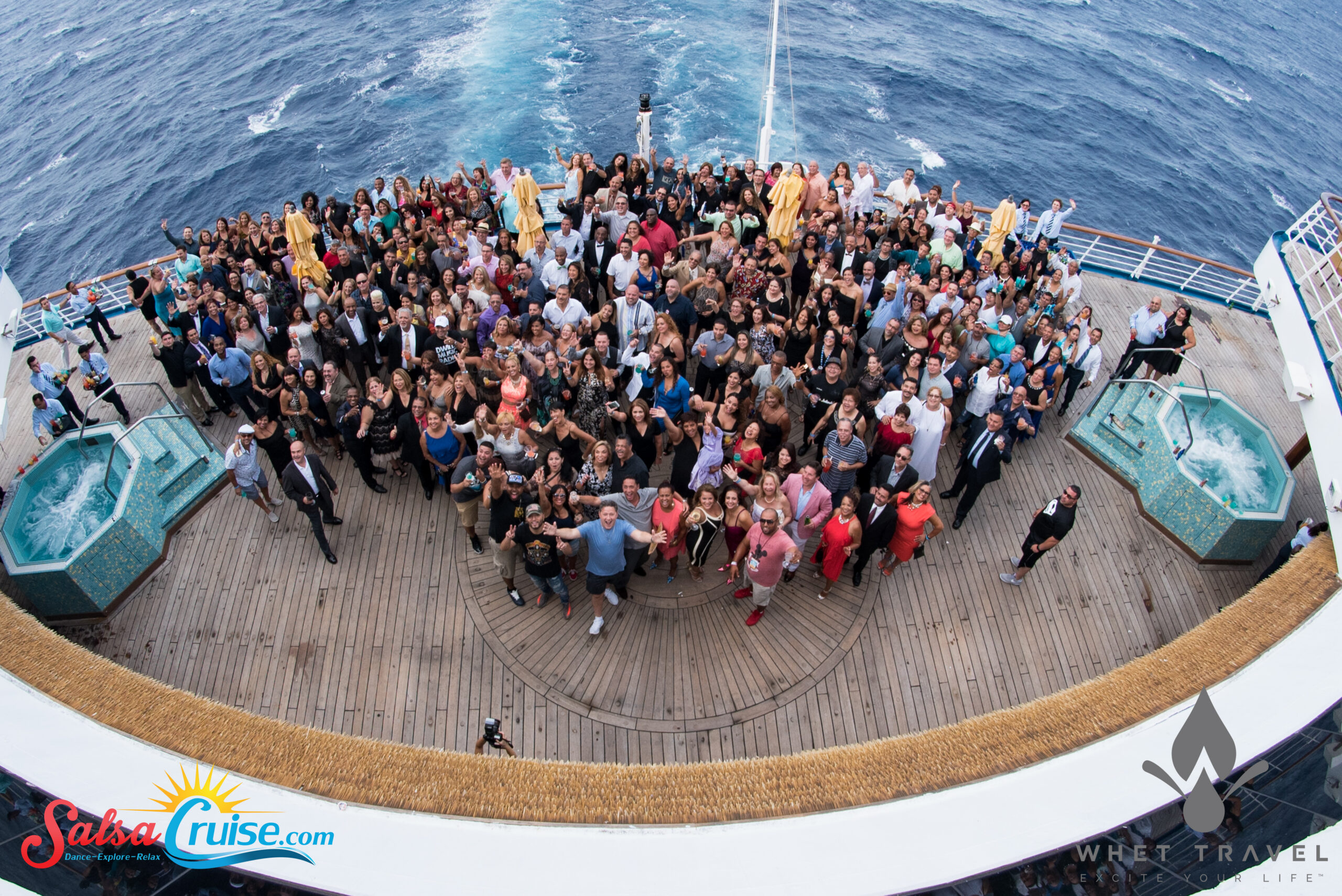 Large group gathered on a ship deck for a group photo.