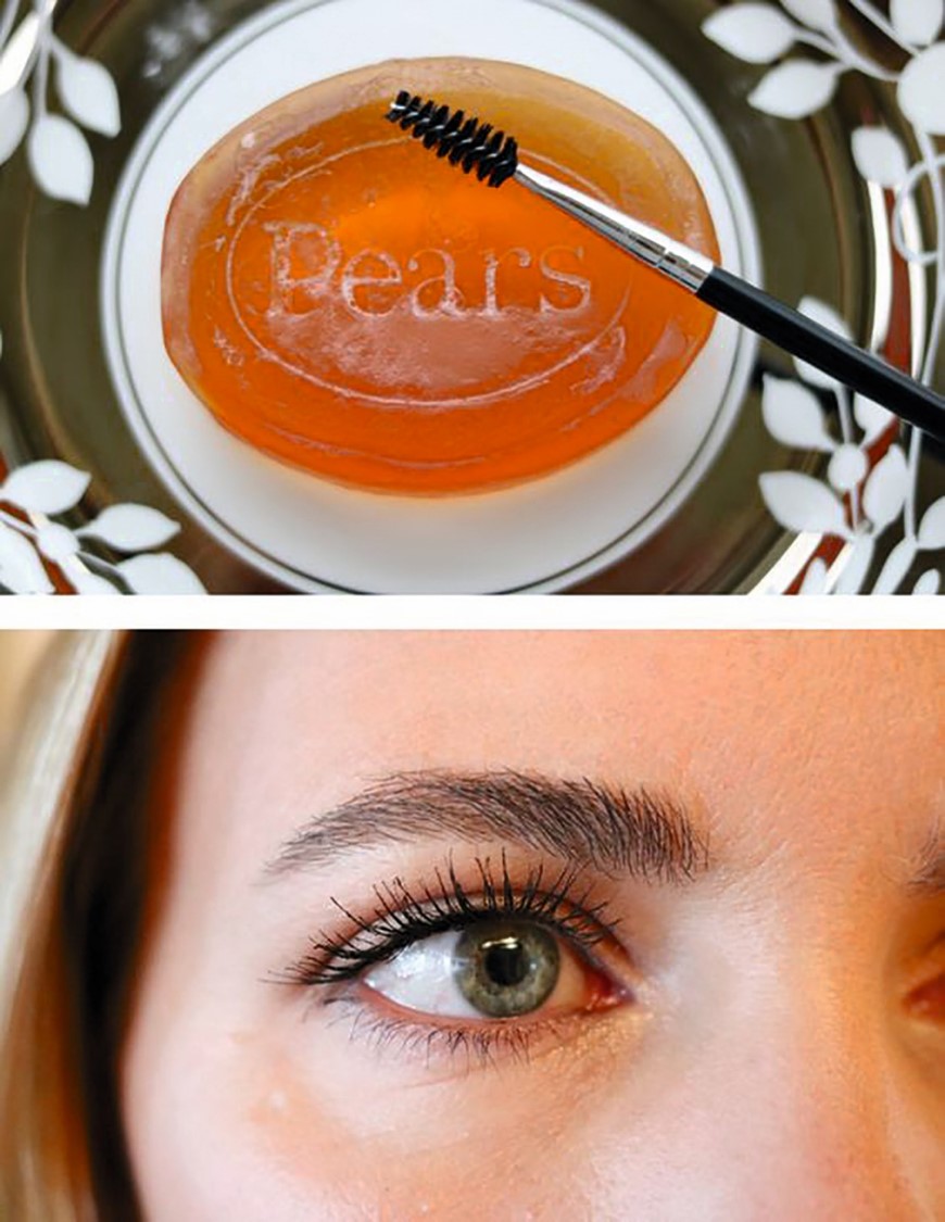 Close-up of an eye with mascara and a mascara wand over an orange gel pot.