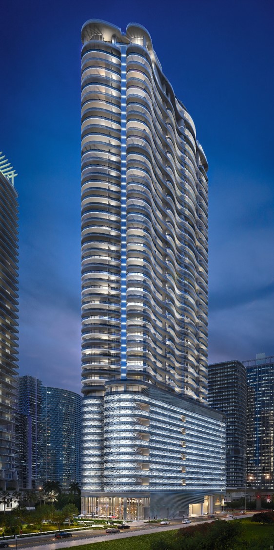 Modern high-rise building with illuminated balconies at night.