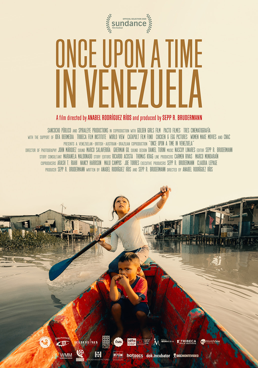 A man paddling a boat with children in a Venezuelan river setting.