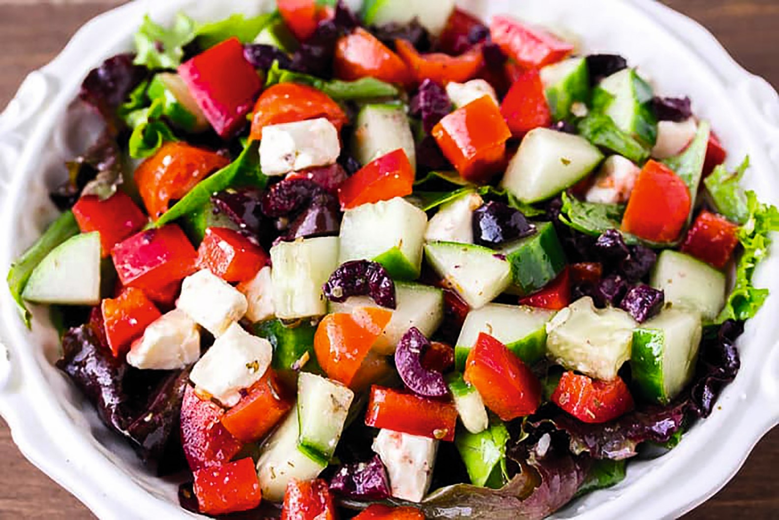 Fresh Greek salad with tomatoes, cucumbers, olives, and feta cheese.
