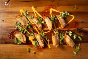 Tasty tacos drizzled with creamy sauce and garnished with herbs.