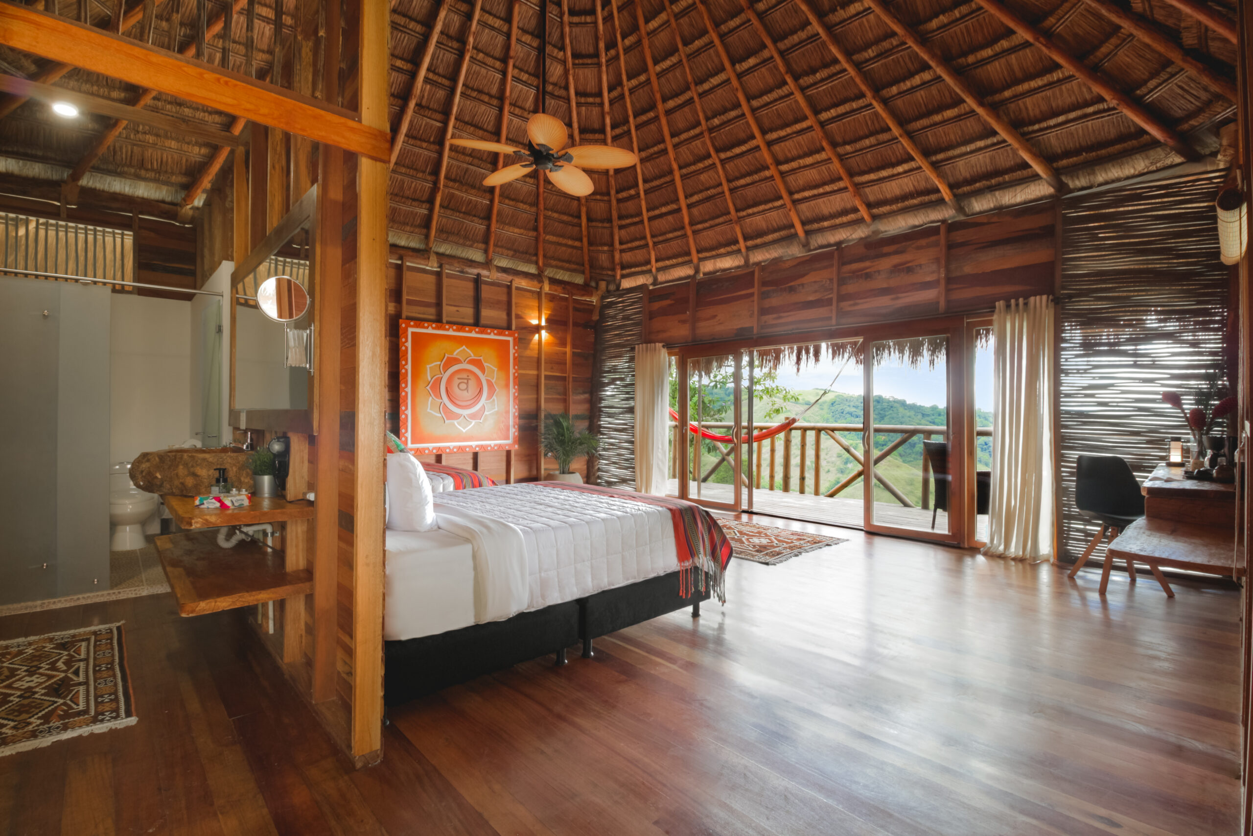 Cozy rustic bedroom with wooden accents and balcony view.