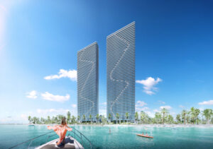 Two modern skyscrapers with a unique spiral design near a waterfront.