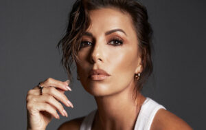 Close-up portrait of a woman with styled hair and elegant makeup.