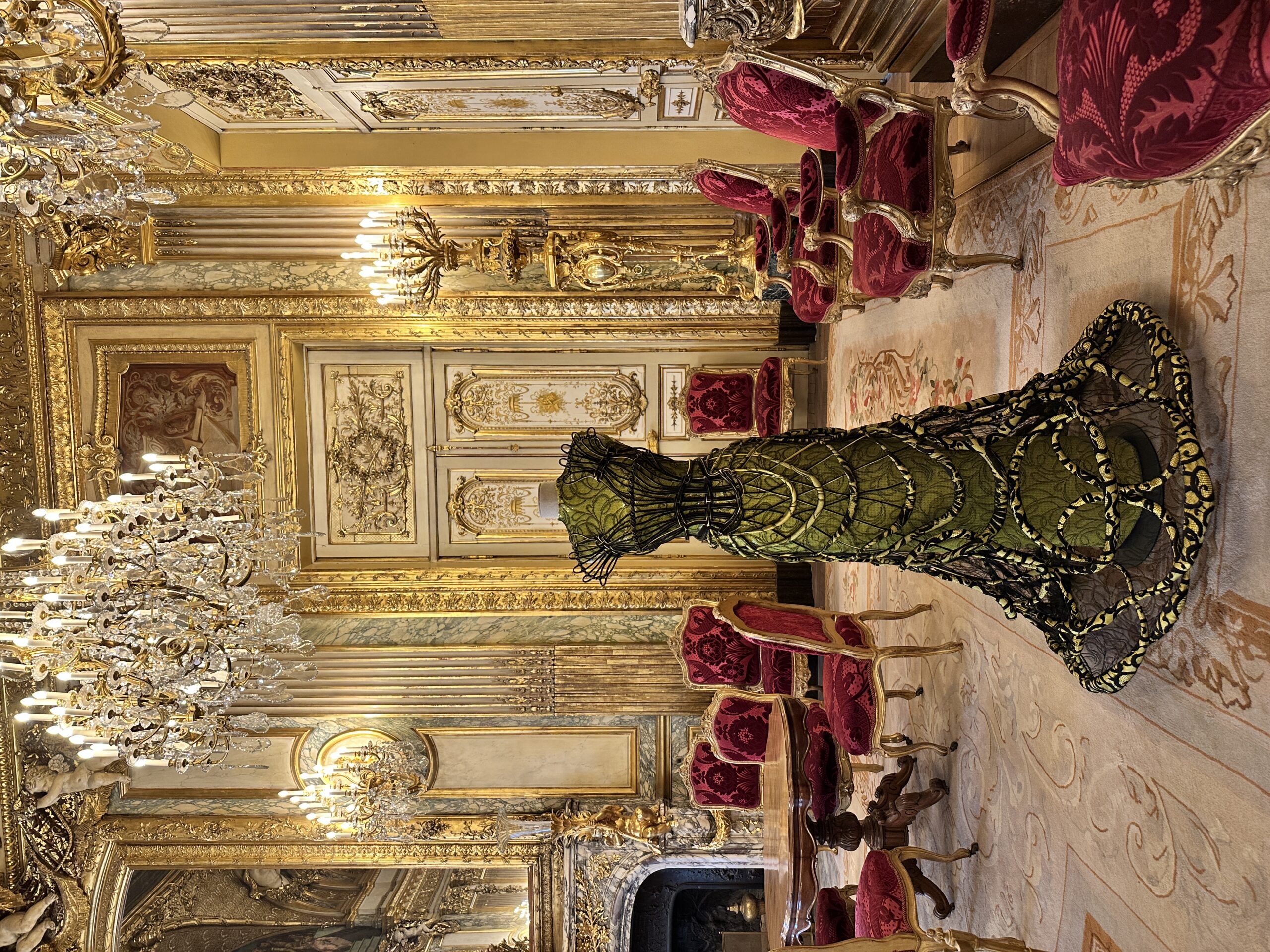 Luxurious vintage room with ornate gold details and elegant furnishings.
