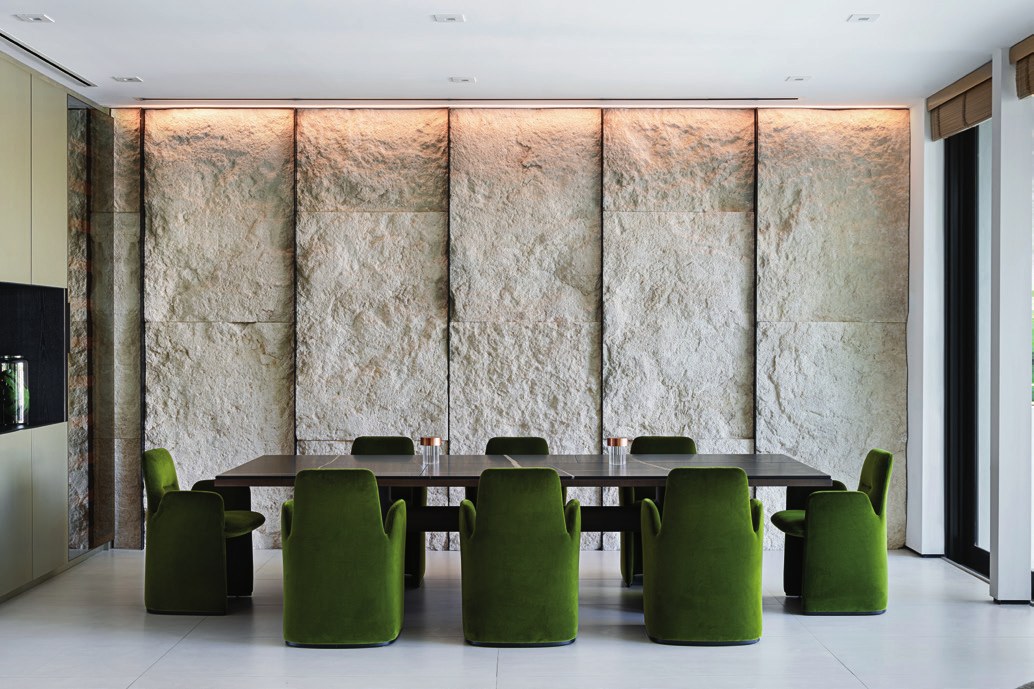 NAR Design Studio dining room with natural stone wall