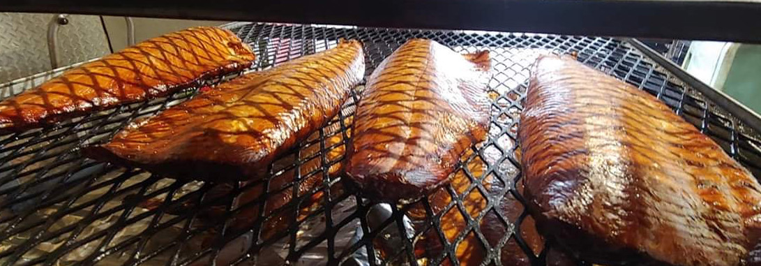 Smoked fish fillets on racks at the Mrs. Peters smokehouse