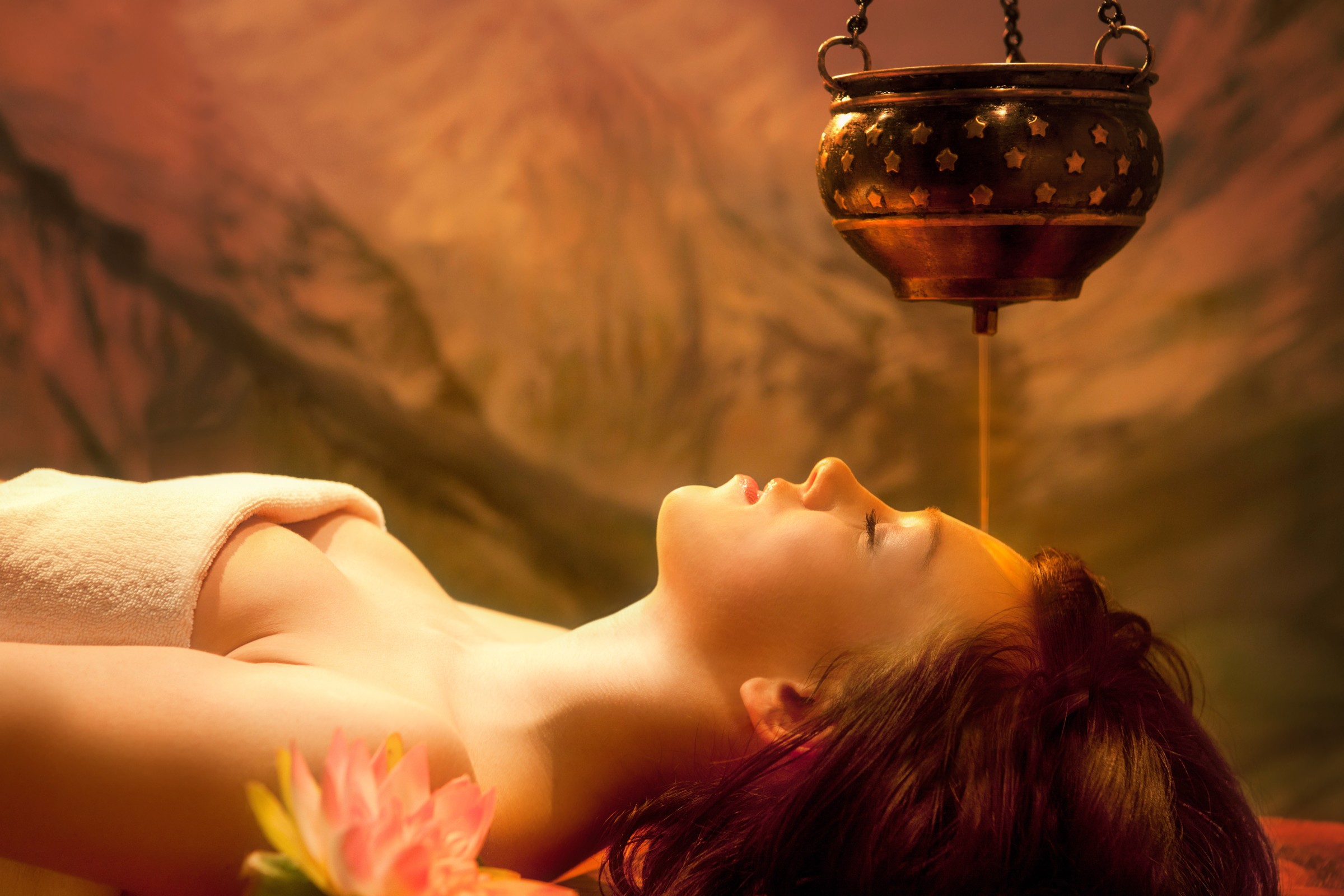 Shirodhara: warm oil flowing over a woman's forehead at Jothi Vita Ayurvedic Spa