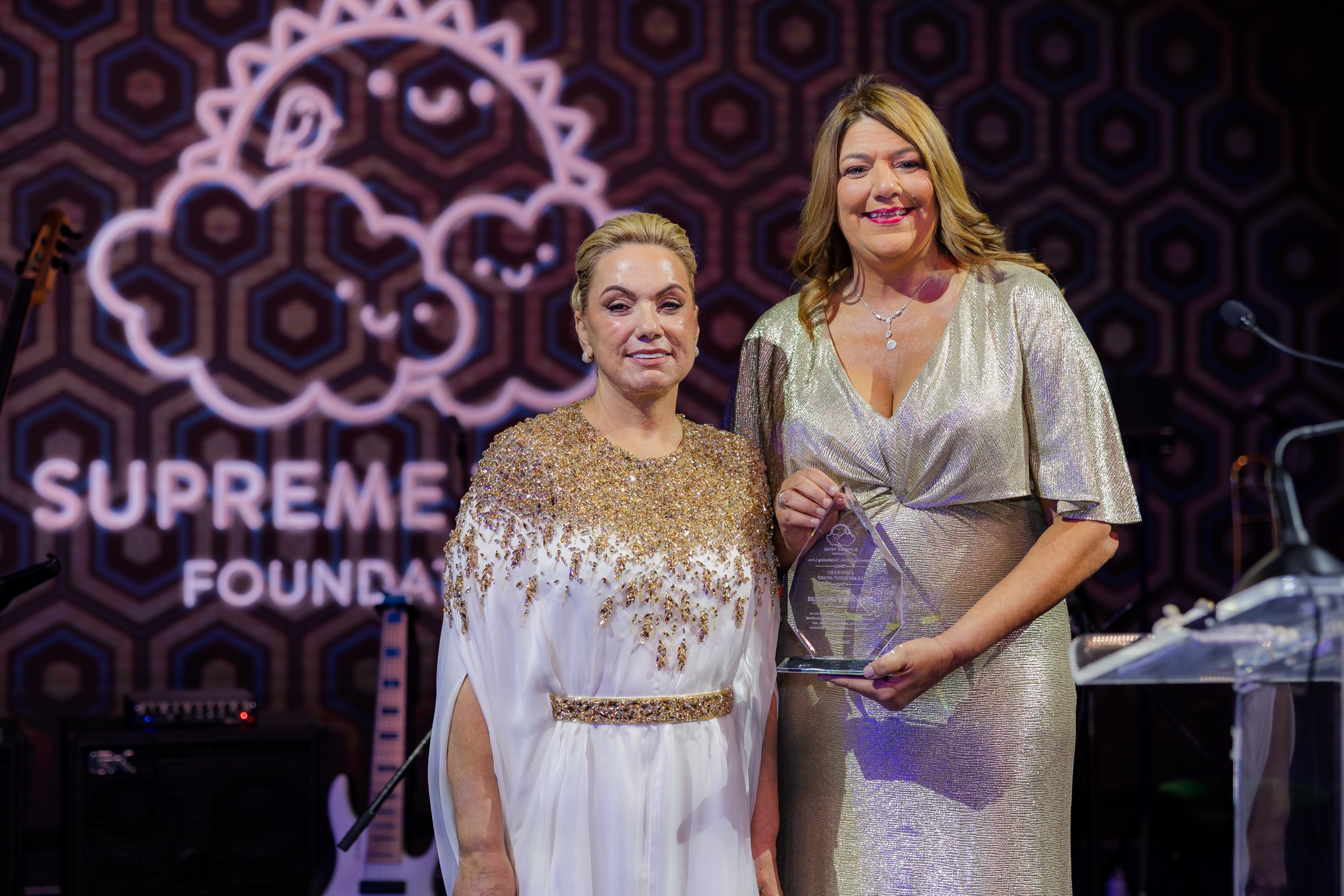 Ilieva Valdés and Madeline Pumariega with the award at the Supreme Twins Foundation 2nd Annual Gala