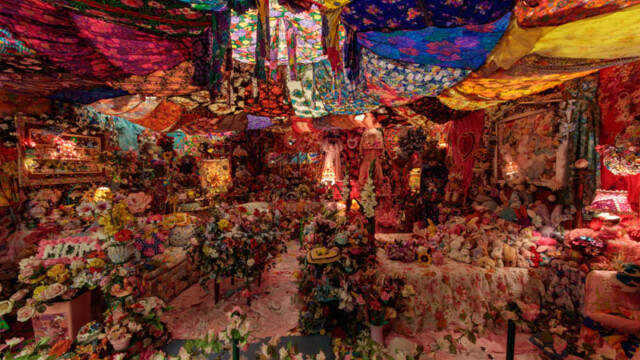 A vibrant, colorful festival scene filled with decorations and lights.