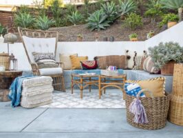 Cozy outdoor seating area with cushions and plants.