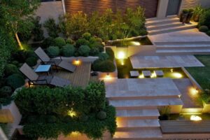 Lighting in Garden Modern garden with illuminated steps and seating area at night.