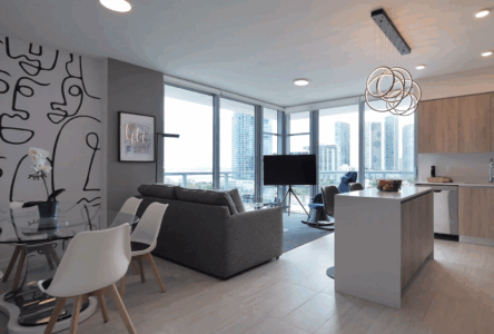 Modern living room with large windows and city views.