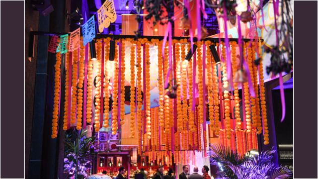 Vibrant marigold decorations illuminate a festive event at night.