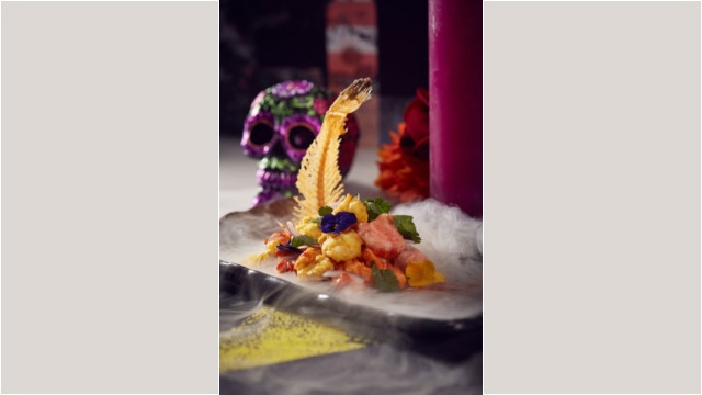 Elegant gourmet dish with vibrant edible flowers and artistic presentation.