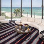 Luxurious beachside lounge with ocean views and elegant seating.
