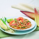 Plate of fresh Thai papaya salad with lime and chili.
