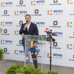 A man speaks at a Metro Expo event podium.