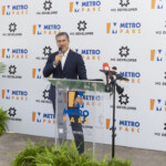 A man speaks at a Metro Expo event podium.