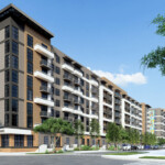 Modern multi-story apartment complex with balconies and surrounding greenery.