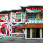 Colorful building with geometric mural and Winter Garden entrance.