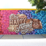 Colorful mural reading 'One Happy Art Island' with tropical design elements.