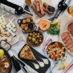 A vibrant spread of assorted appetizers and drinks on a table.