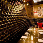 Elegant wine cellar wall with a cozy dining setup.
