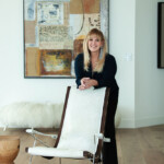 Woman sitting on a modern chair in a stylish living room.