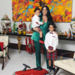 A woman with two children posing in a colorful living room.