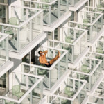 Man relaxing on a balcony surrounded by glass structures.