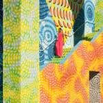 Colorful geometric mural with a person in a red coat.