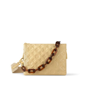 Beige quilted handbag with a chunky brown chain strap on a white background.