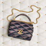 Luxury black quilted LV handbag with gold chain strap.