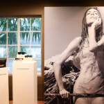 Black and white photo of a woman in a swimsuit displayed in a gallery.
