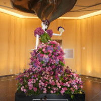 A floral dress sculpture with vibrant pink and purple flowers.