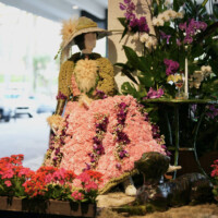 Floral dress mannequin adorned with pink and purple flowers.
