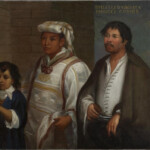 A historical portrait of three individuals in traditional attire against a dark background.