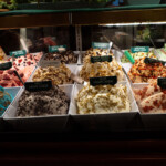 Assorted gelato flavors displayed in a shop.