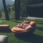 Modern outdoor round lounge chair with cushions on a green lawn.