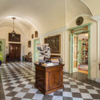 Elegant hallway with checkered floor and classical decor.