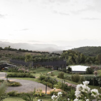 ©AlexFilz . Adler Sicily 2022 Scenic view of a winding path through lush greenery and hills under a cloudy sky.