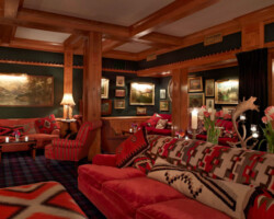 Cozy living room with warm lighting and rich red decor.