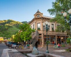 Downtown Aspen, Colorado. Historic building with outdoor seating in a lively city plaza.