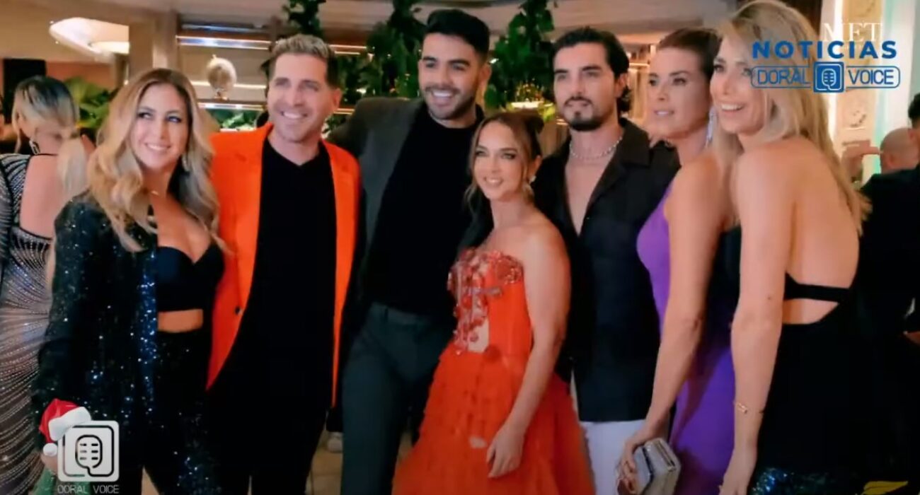 Five people dressed elegantly at a formal event.