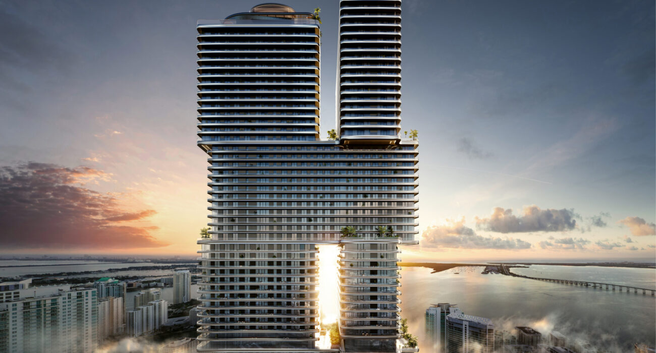 Modern twin skyscrapers with a sunset view and reflective glass facade.