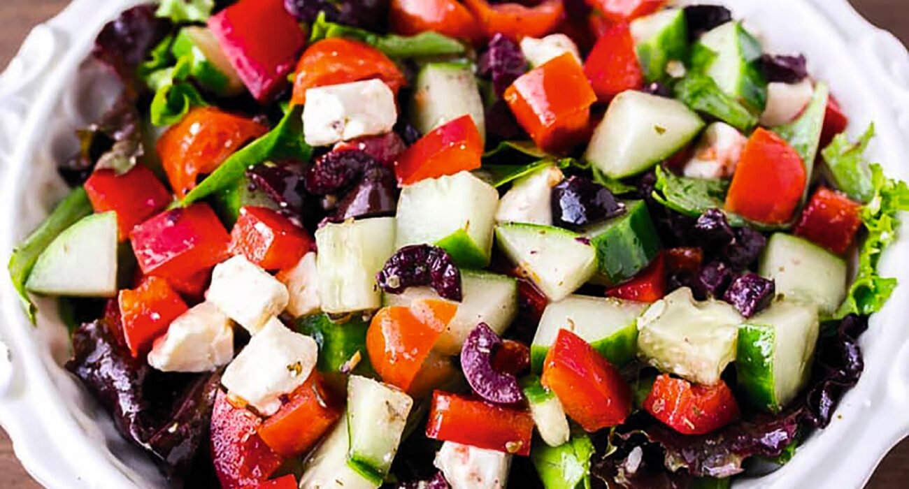 Fresh Greek salad with tomatoes, cucumbers, olives, and feta cheese.