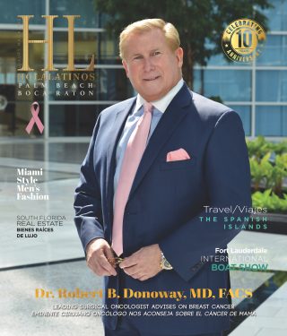 Retrato del Dr. Robert H. Domansky con traje, corbata rosa y pañuelo de bolsillo.