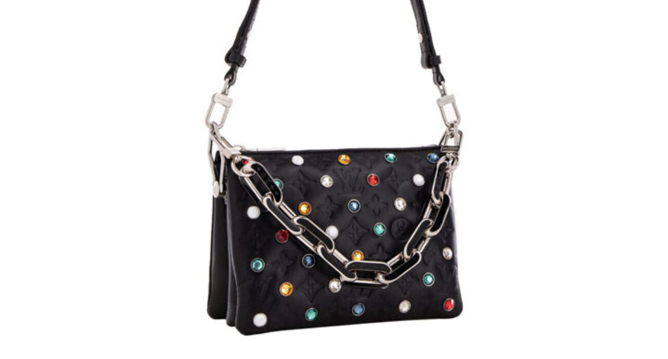 Black handbag with colorful studs and a silver chain strap.